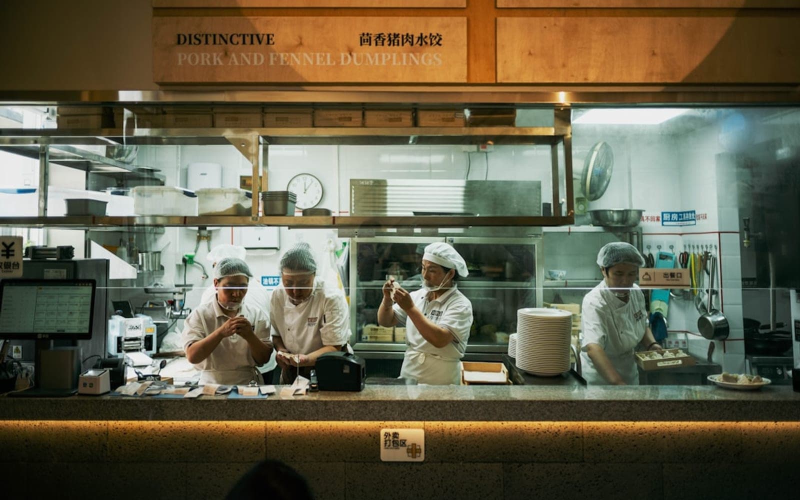 Hospitality kitchen team preparing food in service