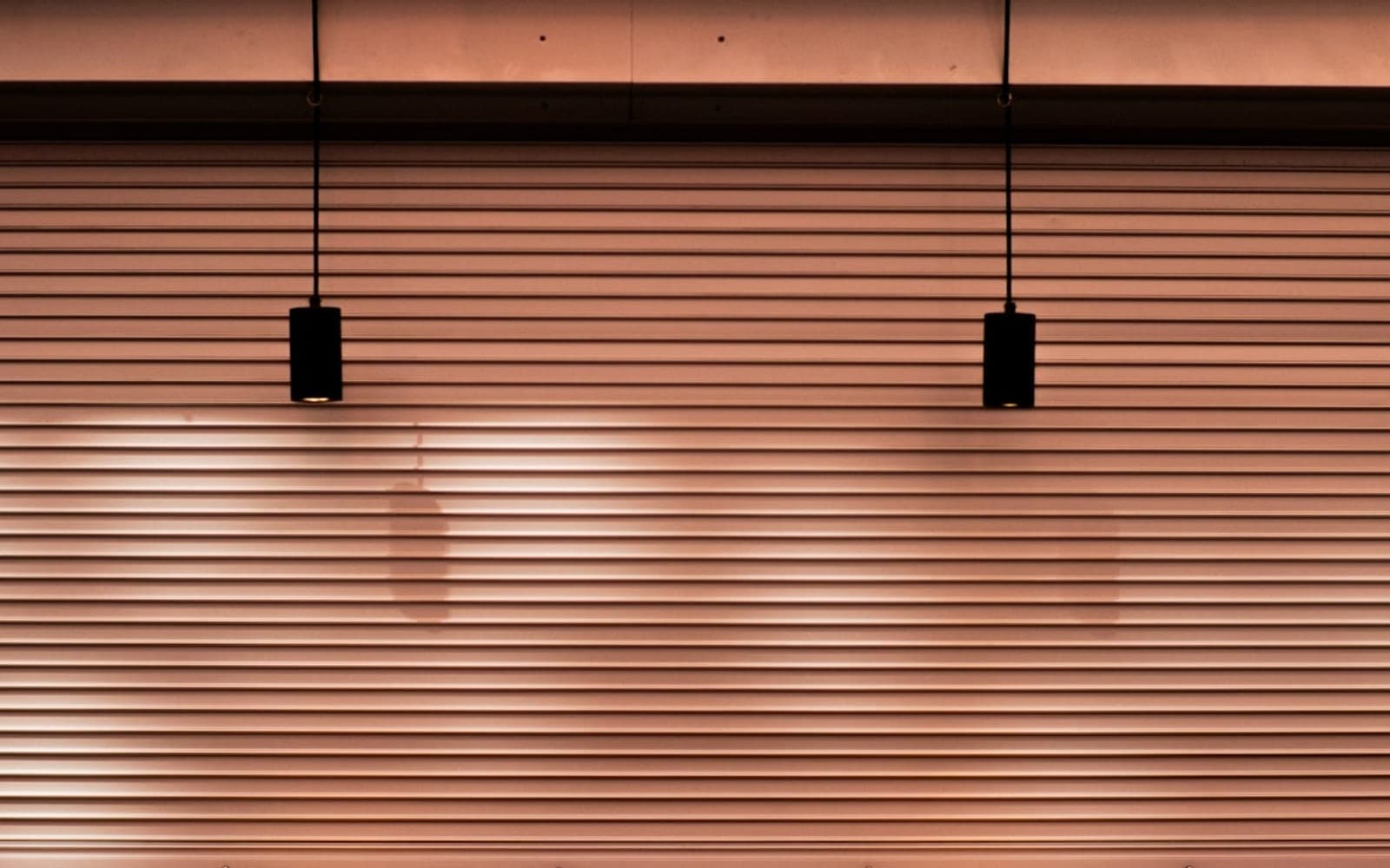 Closed restaurant window with empty tables visible inside